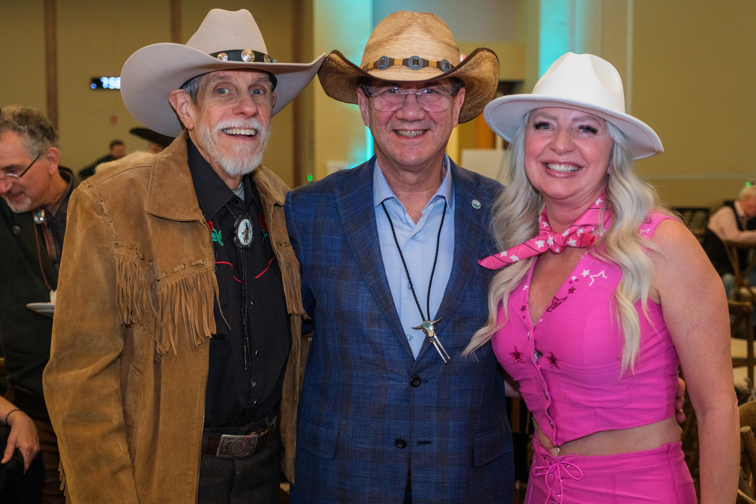 WVSOM President James Nemitz, center, joins Dr. Bob Foster, at left, and guest for a photo at WVSOM's Wild West Benefit to Bob Foster, who recently retired after 45 years of service to the school,