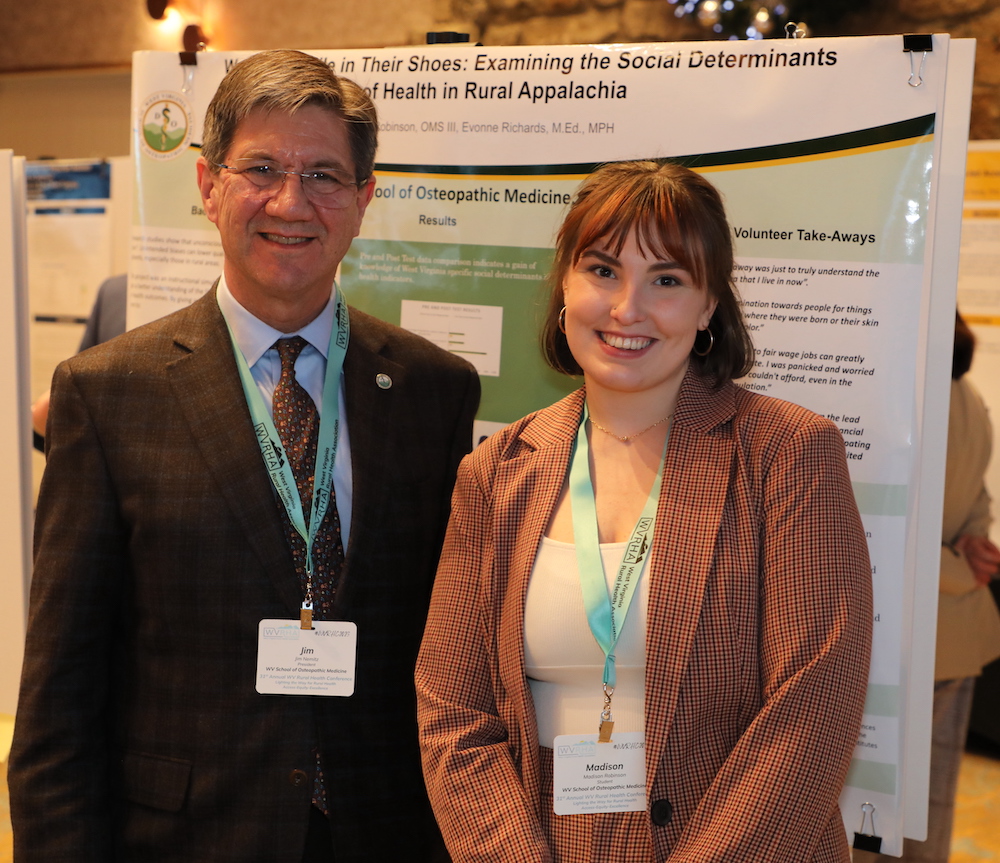 WVSOM President James W. Nemitz stands with third-year student Madison Robinson at her poster. 