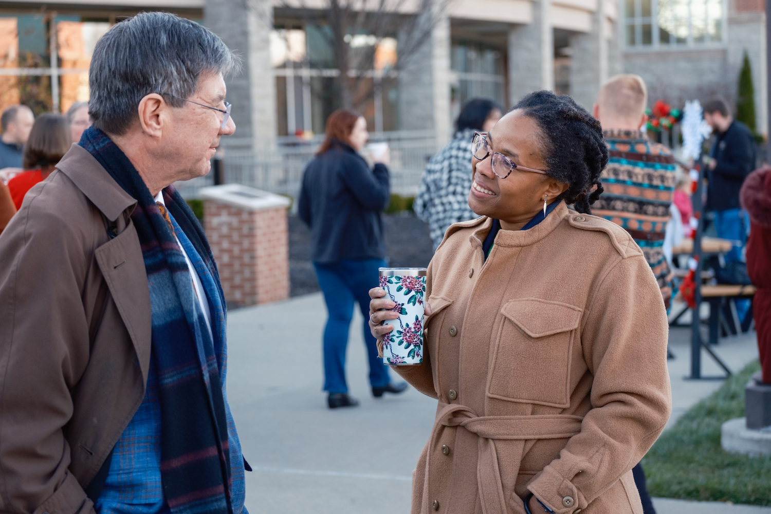 two people talk at the WVSOM Holiday Kickoff: President James Nemitz, Ph.D, talks with Dr. Dawn Roberts, Ed.D., associate dean of multicultural and student affair
