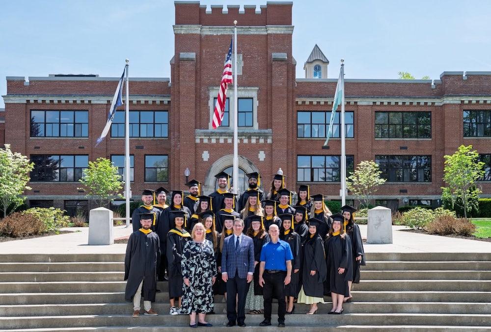 large group of people on steps in caps and gowns.