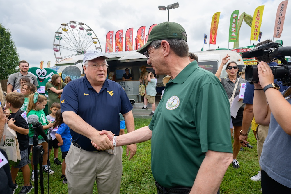 two men shake hands in a crowd