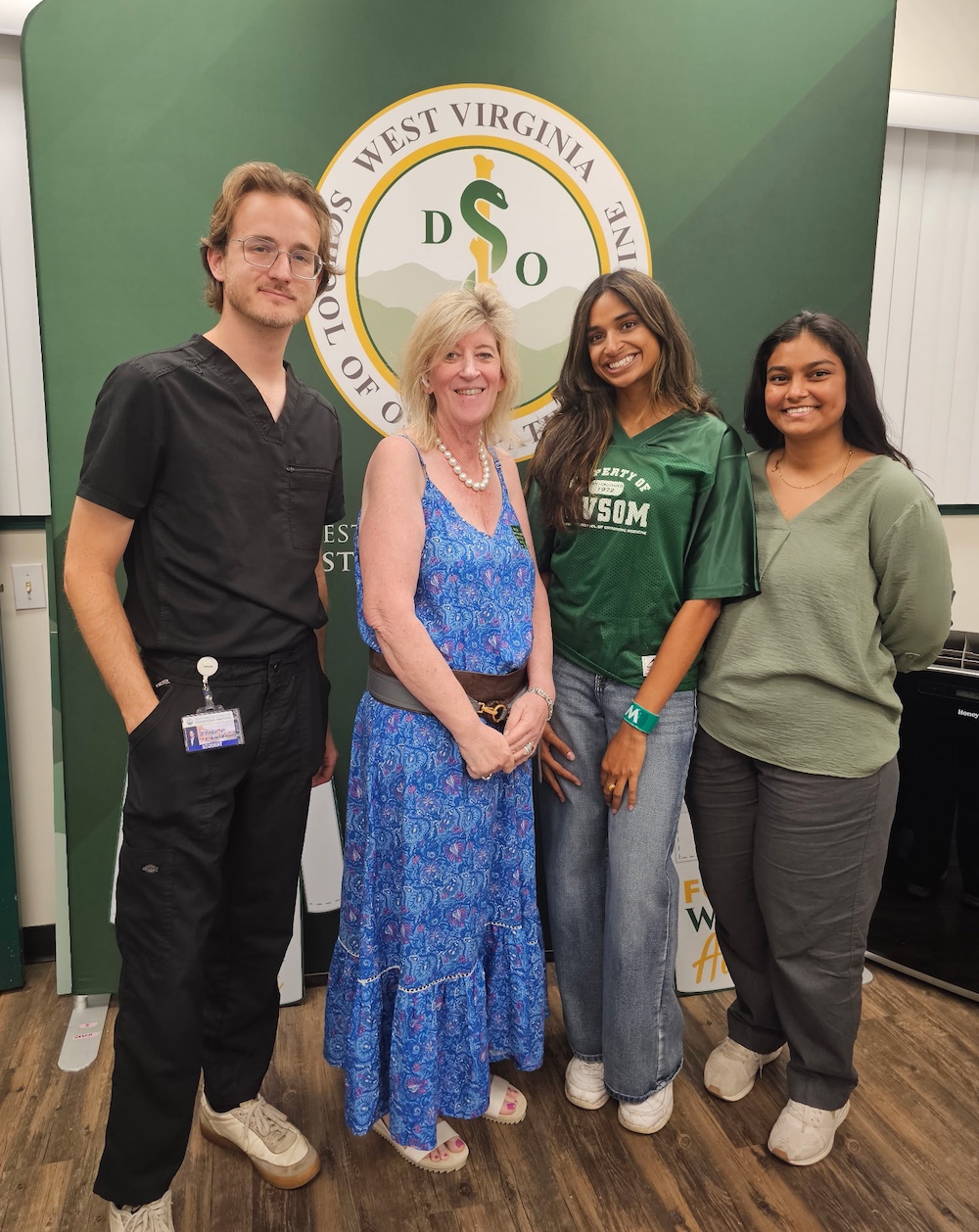 man and three women pose for a photo.