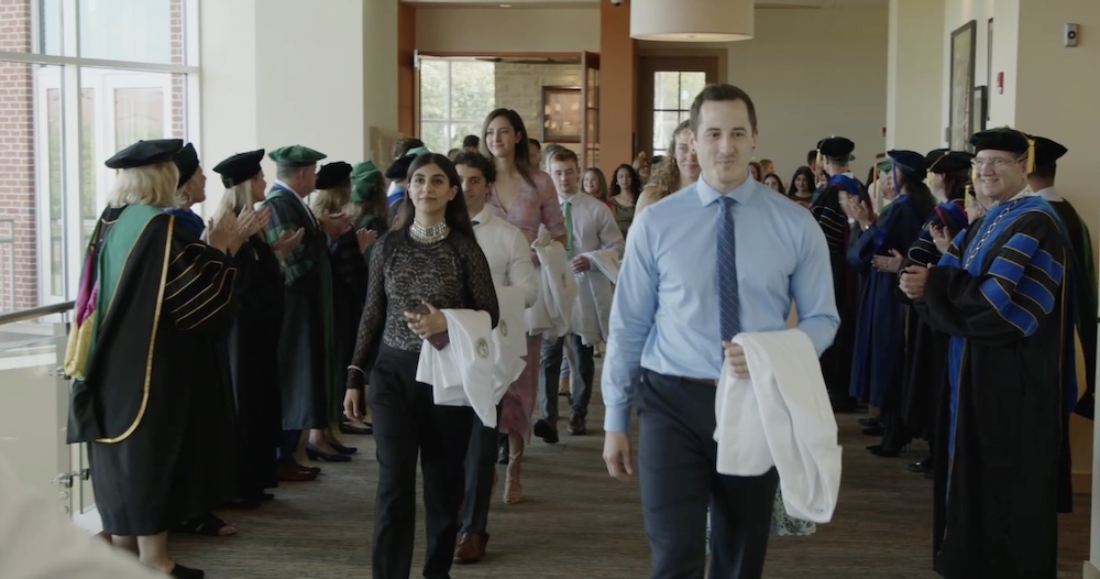 four long lines of people standing