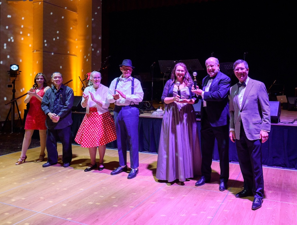 Seven people stand on dance floor