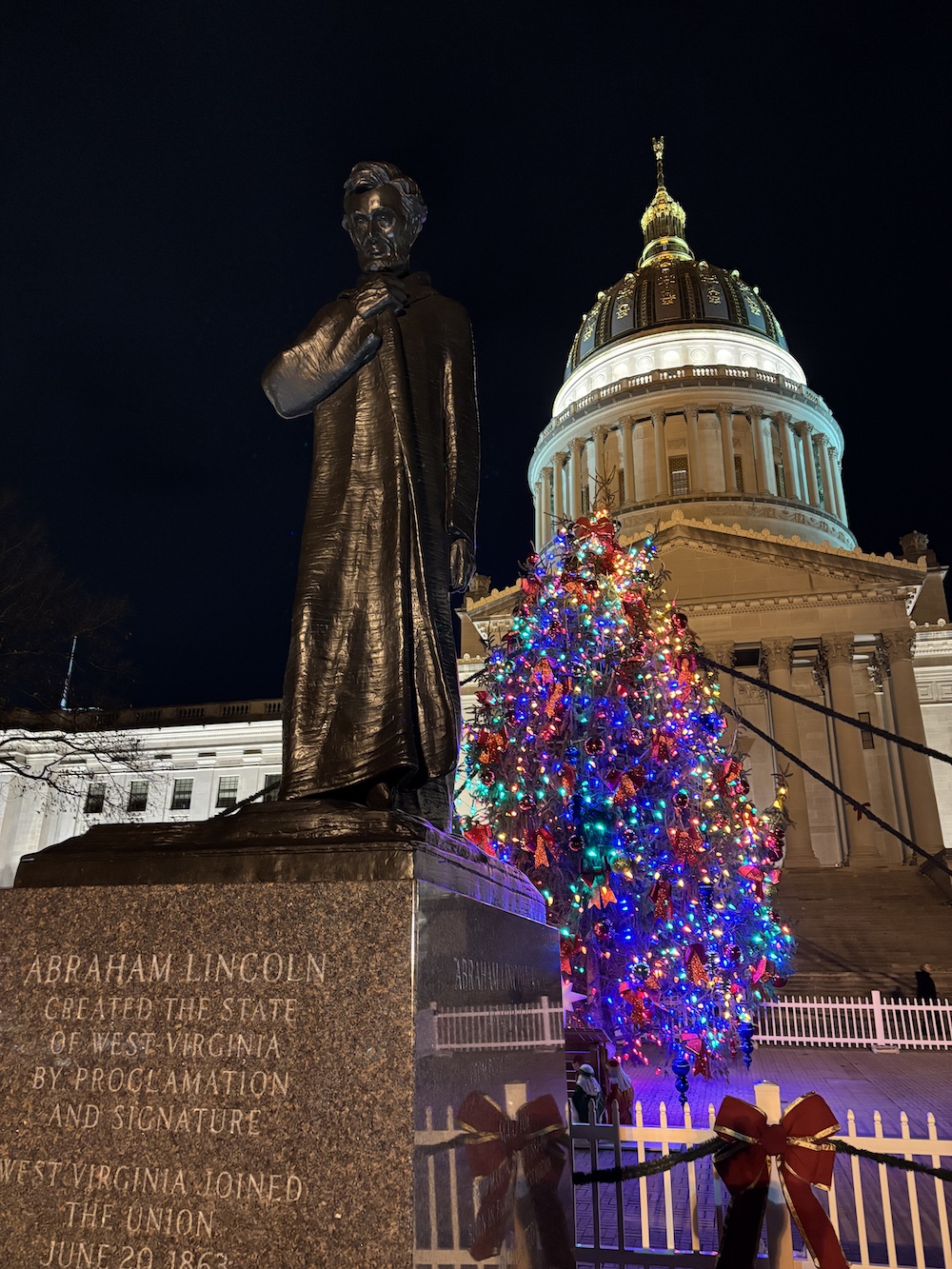 Holiday lights, a statue and the state capitol dome. 