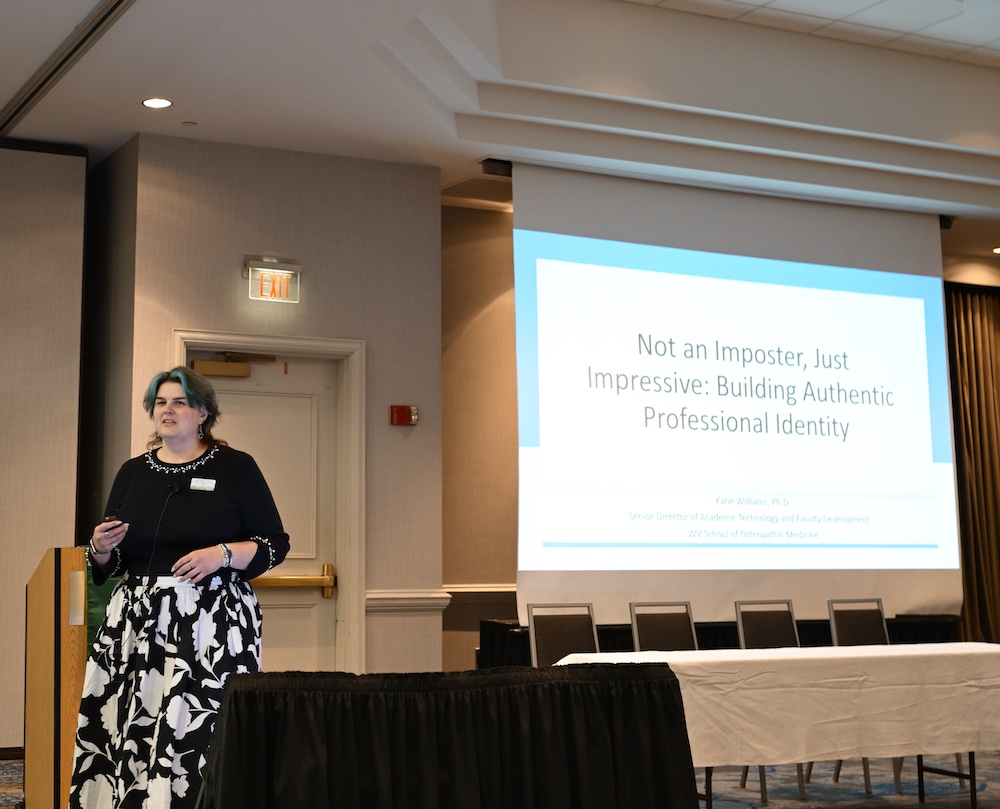 woman speaks near a screeen