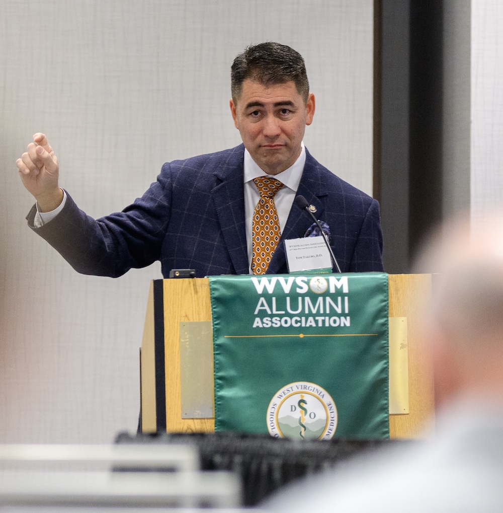 Man speaks at podium