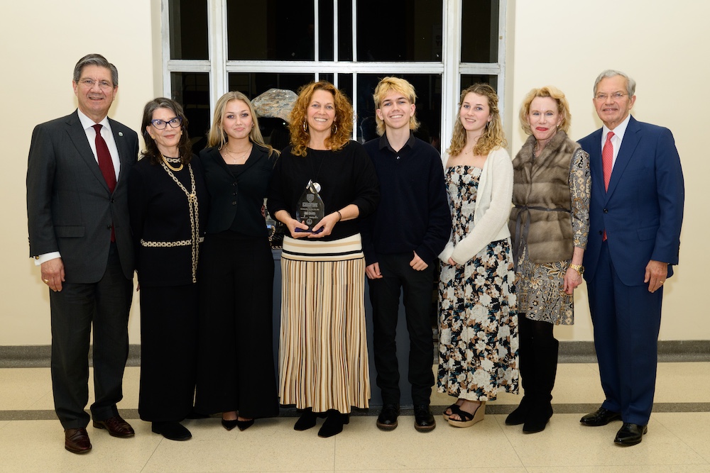 Eight people line up for an award presentation