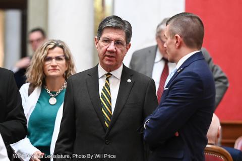 Three people standing and having a conversation