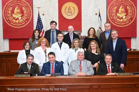 Three rows of people gathered in WV Senate chamber for a photos