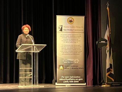 Woman talks at podium during MLK event in Charleston