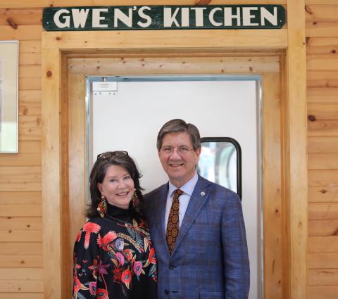 Man and Woman standing in front of a door. 