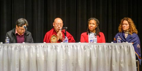 Two men and two women sit at a table. 