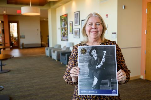 Woman holds up a picture