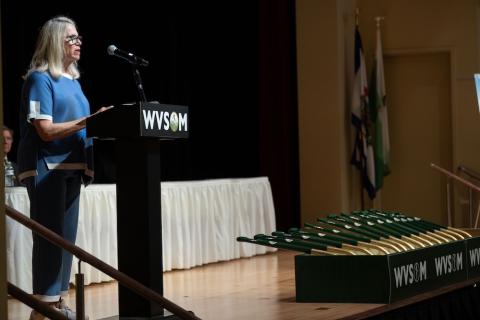 woman stands at podium 
