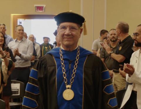 Man walking in college outfit