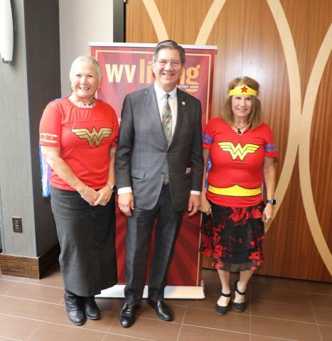 man stands between two women