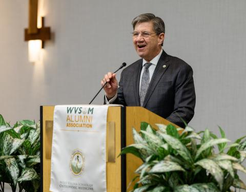 Man speaks at podium